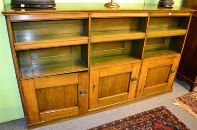 Lot 1370 - A three section open bookcase with three cupboard doors below