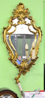 Lot 1374 - A gilt wood mirrored wall sconce in the rococo taste (a.f)