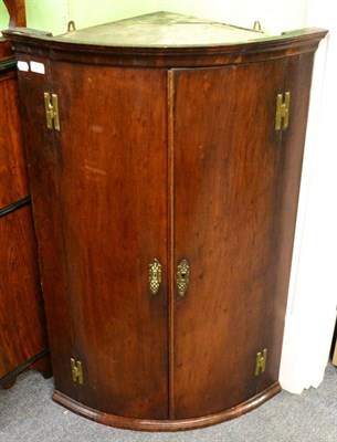 Lot 1389 - An early 19th century mahogany corner cabinet