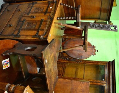 Lot 1399 - A 19th century oak spinning wheel chair; a carved oak stool decorated with a crest; (2)