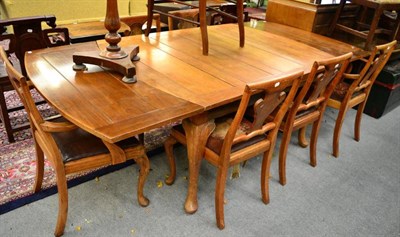 Lot 1411 - A dining room suite comprising a dining table, six chairs and a sideboard, stamped Wylie and...