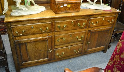 Lot 1442 - A George III oak sideboard, with five drawers and two cupboard doors