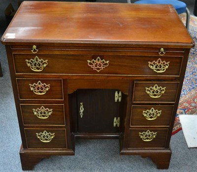 Lot 1444 - A George III mahogany kneehole dressing table with re-entrant corners