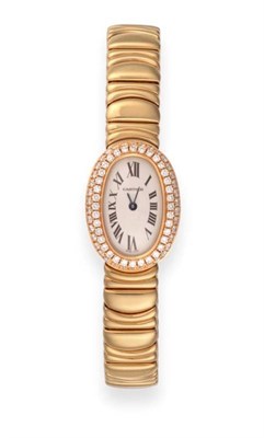 Lot 124 - A Lady's 18ct Gold Diamond Set Oval Shaped Wristwatch, signed Cartier, model: Baignoire, ref: 2368