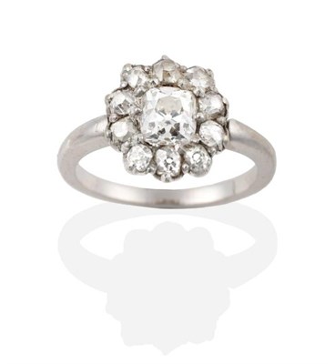 Lot 148 - A Diamond Cluster Ring, an old mine cut diamond within a border of old cut diamonds, estimated...