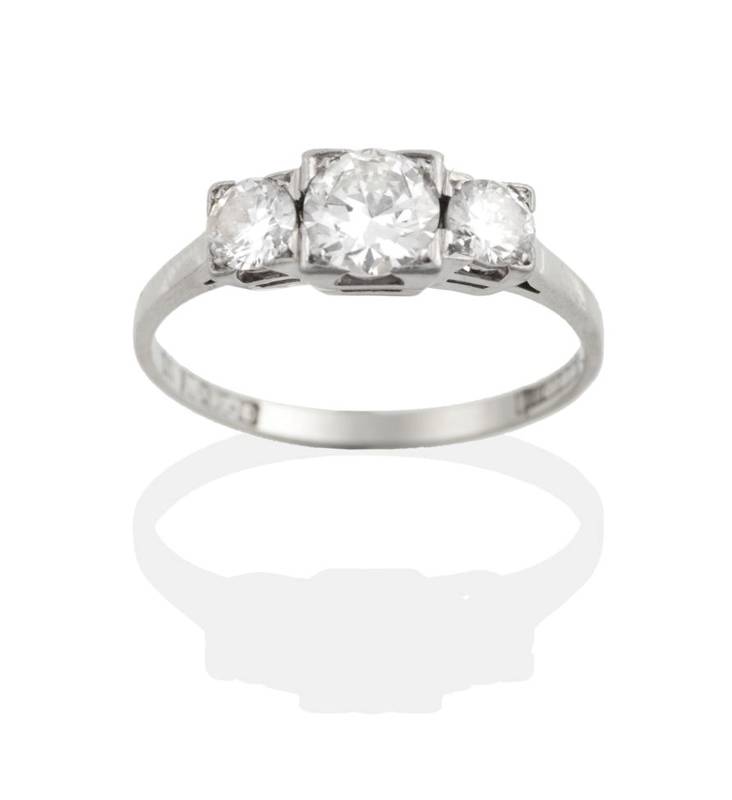 Lot 158 - A Diamond Three Stone Ring, graduated round brilliant cut diamonds in square settings, total...