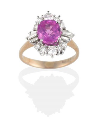 Lot 170 - A Pink Sapphire and Diamond Cluster Ring, a cushion cut pink sapphire in a claw setting, within...
