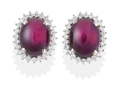Lot 172 - A Pair of Star Ruby and Diamond Cluster Earrings, oval cabochon star rubies in claw settings,...