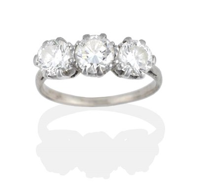 Lot 174 - A Diamond Three Stone Ring, graduated round brilliant cut diamonds in claw settings, to knife...