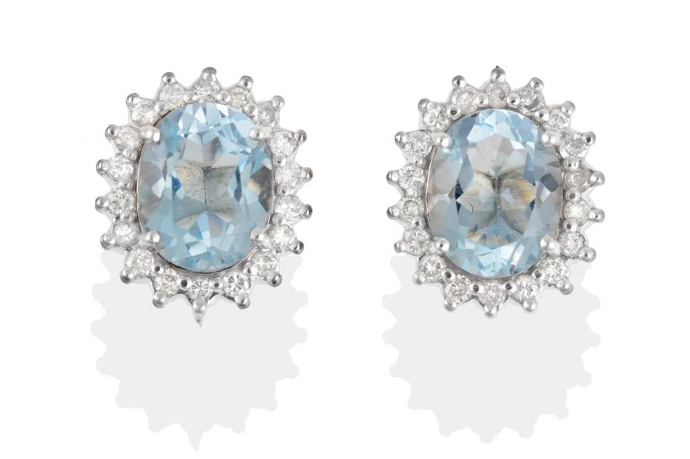 Lot 181 - A Pair of Aquamarine and Diamond Cluster Earrings, oval cut aquamarine in claw settings, within...
