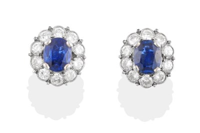 Lot 186 - A Pair of Sapphire and Diamond Cluster Earrings, oval cut sapphires within a border of round...