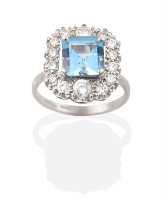 Lot 188 - An Aquamarine and Diamond Cluster Ring, an octagonal cut aquamarine in a claw setting, within a...