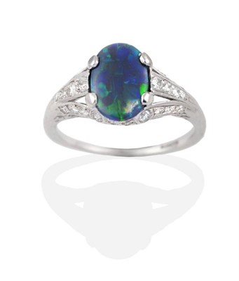 Lot 209 - A Circa 1925 Art Deco Black Opal and Diamond Ring, an oval cabochon opal in a claw setting, to...