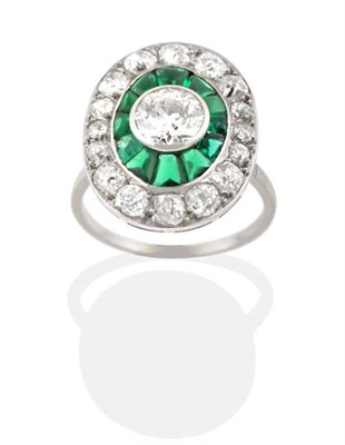Lot 215 - An Art Deco Diamond and Green Stone Cluster Ring, an old cut diamond in a rubbed over setting...
