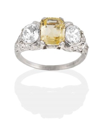 Lot 222 - A Circa 1930s Yellow Sapphire and Diamond Three Stone Ring, an octagonal cut yellow sapphire in...