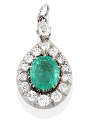 Lot 225 - An Emerald and Diamond Pendant, an oval cut emerald in a collet setting within a border of old...