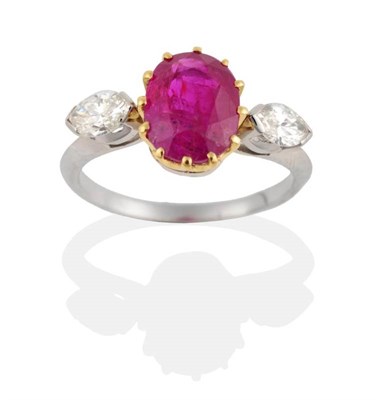 Lot 227 - A Ruby and Diamond Three Stone Ring, an oval cut ruby in a claw setting, spaced by marquise cut...