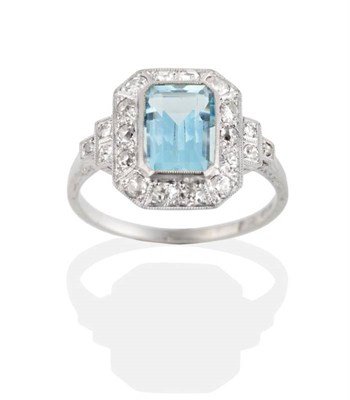 Lot 233 - An Aquamarine and Diamond Cluster Ring, a grain set octagonal cut aquamarine, within a...