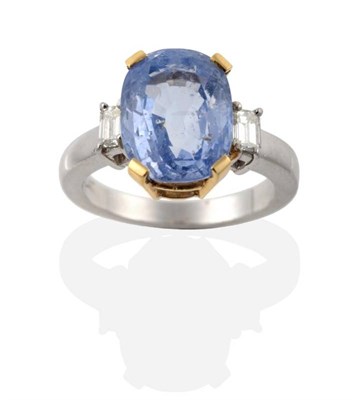 Lot 237 - A Sapphire and Diamond Three Stone Ring, an oval cut sapphire in a claw setting, spaced by baguette