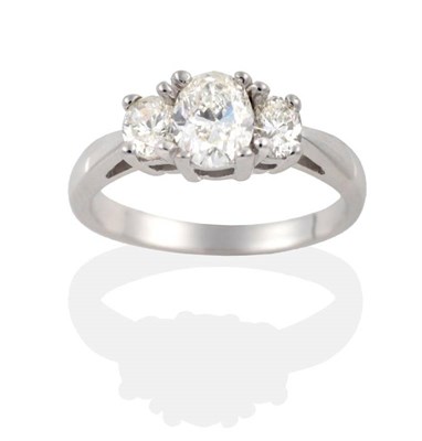 Lot 242 - A Diamond Three Stone Ring, graduated oval cut diamonds in claw settings, to tapering...