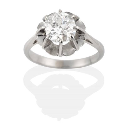 Lot 243 - A Cushion Cut Solitaire Diamond Ring, in a claw setting above an extended underbezel, to knife edge