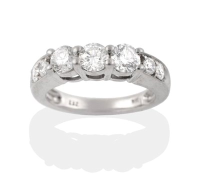 Lot 244 - A Diamond Ring, three round brilliant cut diamonds in claw setting, to diamond set tapering...