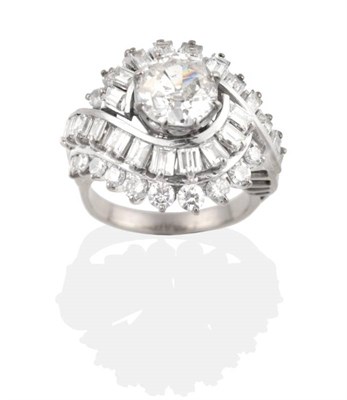 Lot 248 - A Circa 1950s Diamond Cluster Ring, an old cut diamond in a claw setting within a scroll frame...