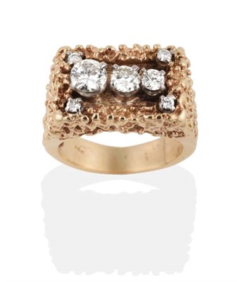 Lot 261 - A Circa 1970s Diamond Ring, seven vari-sized round brilliant cut diamonds to a heavily textured...