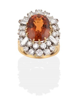 Lot 264 - A Spessartine Garnet and Diamond Cluster Ring, an oval cut spessartine garnet in a claw...
