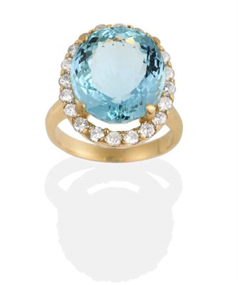 Lot 280 - An Aquamarine and Diamond Cluster Ring, an oval mixed cut aquamarine in a claw setting, within...