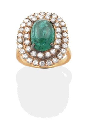 Lot 299 - An Emerald and Diamond Cluster Ring, an oval cabochon emerald in a claw setting, within a two...