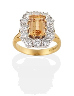 Lot 301 - An 18 Carat Gold Golden Topaz and Diamond Cluster Ring, an octagonal cut golden topaz in a claw...