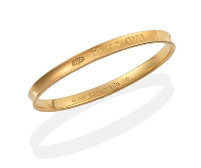 Lot 302 - A Tiffany 1837 Bangle, of grooved design, stamped to the outside '750', 'T&CO', '1837',...