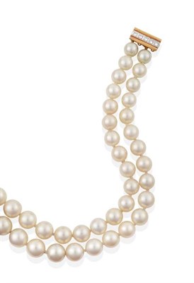 Lot 308 - A Double Strand Cultured Pearl Necklace, with a Diamond Set Clasp, graduated cultured pearls...