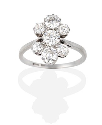 Lot 313 - A Diamond Cluster Ring, a central old cut diamond flanked by groups of three graduated old cut...