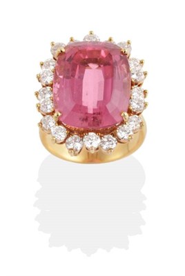 Lot 321 - A Kunzite and Diamond Cluster Ring, a cushion cut kunzite in a claw setting, within an...