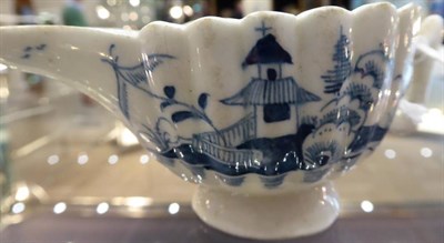 Lot 331 - A Lowestoft Porcelain Butter Boat, circa 1775, of fluted form, painted in underglaze blue with...
