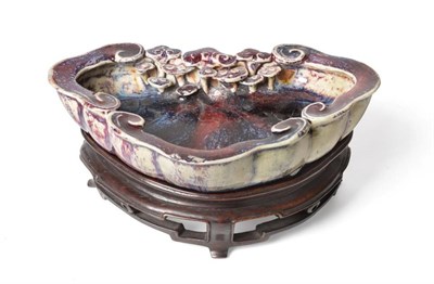 Lot 352 - A Chinese Sang de Boeuf Glazed Brush Washer, probably Yongzheng period, of cloud scroll form...