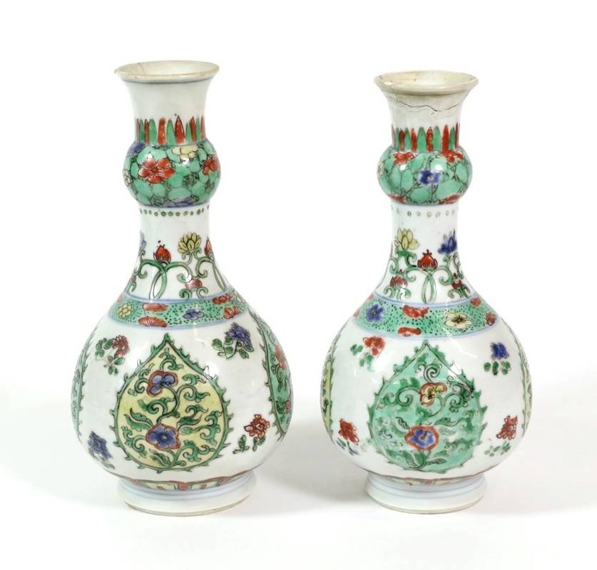 Lot 355 - A Pair of Chinese Porcelain Bottle Vases, Kangxi, with garlic necks, painted in famille verte...