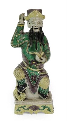 Lot 357 - A Chinese Bisque Porcelain Figure of an Immortal, Kangxi, the seated figure wearing a...