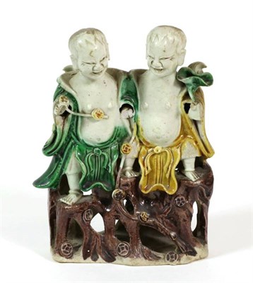 Lot 358 - A Chinese Porcelain Figure Group, Kangxi, as two children sitting on a rocky outcrop decorated...