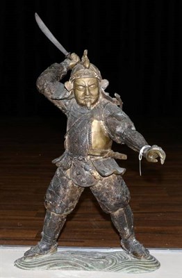 Lot 374 - A Japanese Bronze Figure of a Samurai, Meiji period, standing holding a short sword in his...