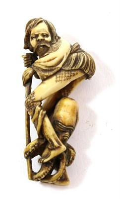 Lot 380 - A Japanese Ivory Netsuke, Edo period, as Ashinaga standing, an octopus holding his feet, 7cm high