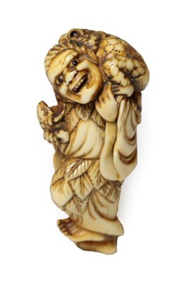 Lot 384 - A Japanese Ivory Netsuke, Edo period, as Gama Sennin standing holding a baby toad, the toad on...