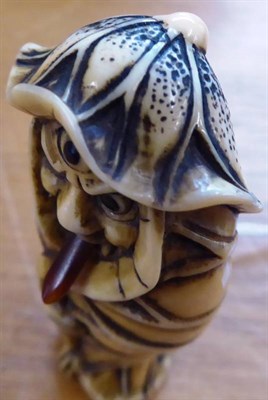Lot 388 - A Japanese Ivory Netsuke, Meiji period, as a Bakemono wrapped in lotus leaves with articulated...