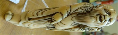 Lot 392 - A Japanese Ivory Netsuke, Edo period, as a Sennin holding an octopus on his left shoulder,...
