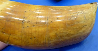 Lot 408 - A Scrimshaw Whale's Tooth, 19th century, engraved with a sailing ship, 18cm long  With attached...