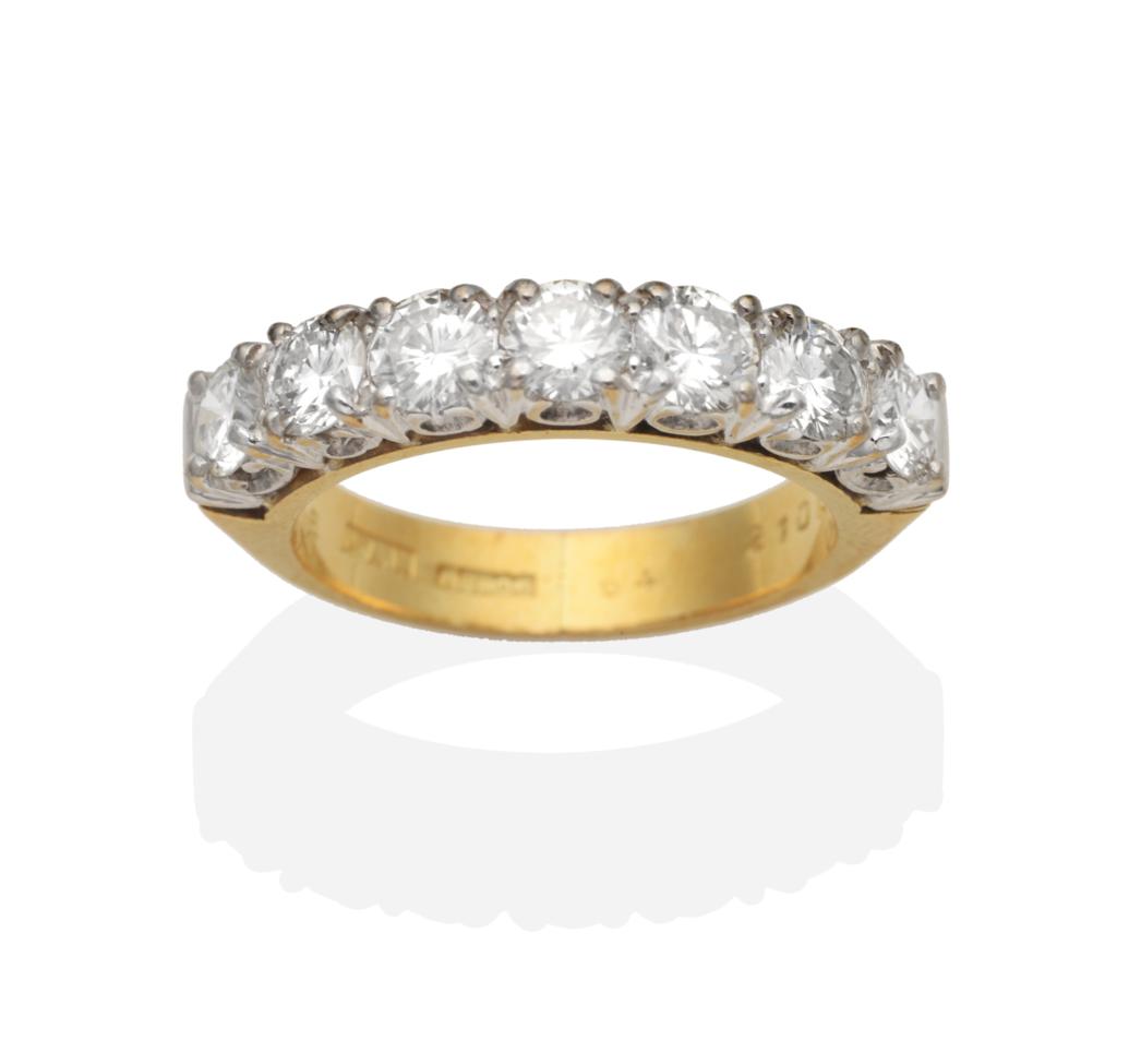 Lot 392 - An 18 Carat Gold Diamond Half Hoop Ring, seven round brilliant cut diamonds in claw settings,...