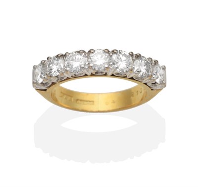 Lot 392 - An 18 Carat Gold Diamond Half Hoop Ring, seven round brilliant cut diamonds in claw settings,...