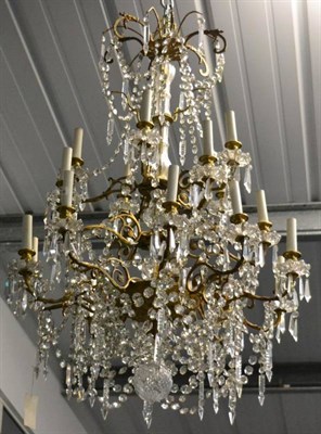 Lot 417 - A Gilt Metal and Cut Glass Twenty Light Chandelier, late 19th century, with campana sconces,...